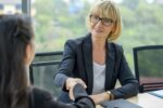 cheerful hr manager handshake with female candidate at job interview business agreement employee