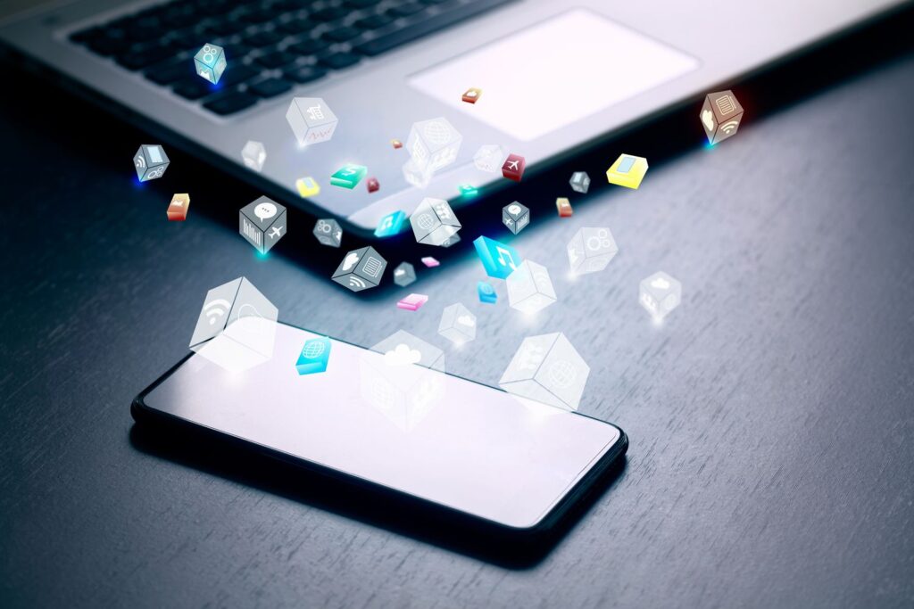 close up of business and smartphone with cloud of colorful application icons business software and