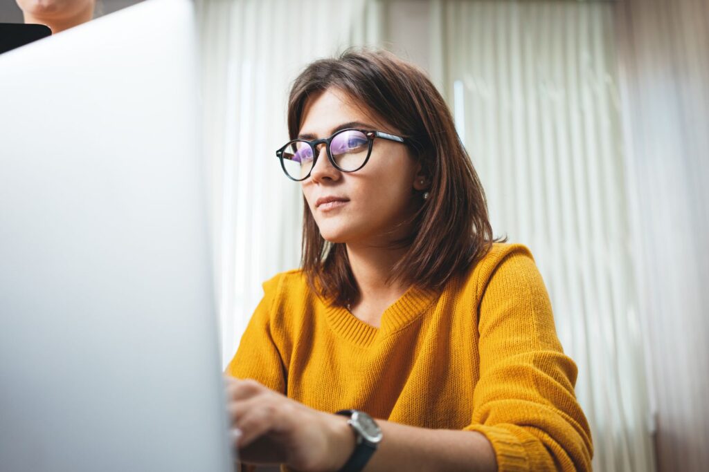 portrait of pensive business woman wearing glasses at workplace in office young handsome female wor
