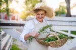 senior woman walking outdoors on farm holding basket with herbs 1180808692 3a84e5b0e00f4e0887a918e